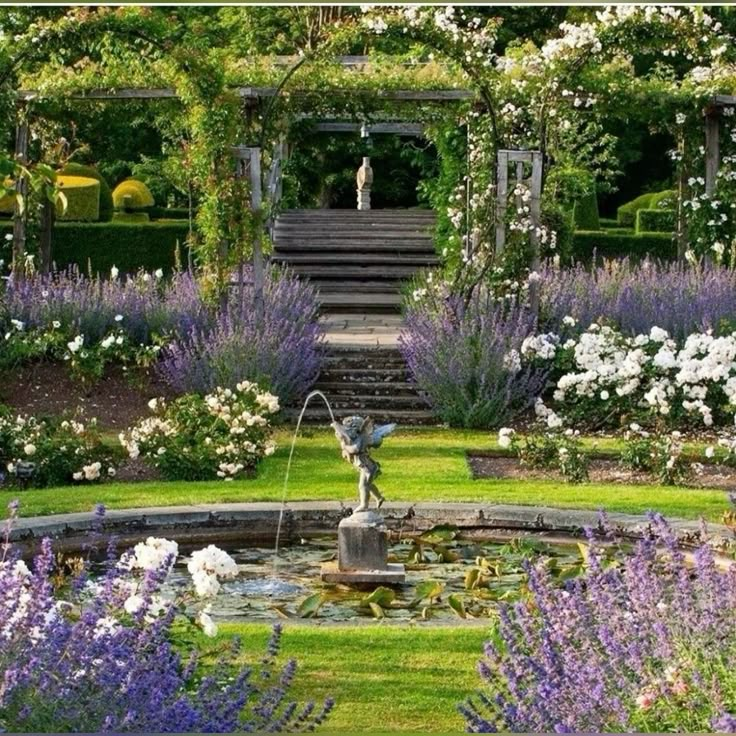 a garden with flowers and steps leading to the water fountain in the center, surrounded by greenery