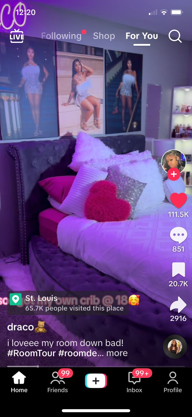 the room is decorated in purple and has pictures hanging on the wall above the bed