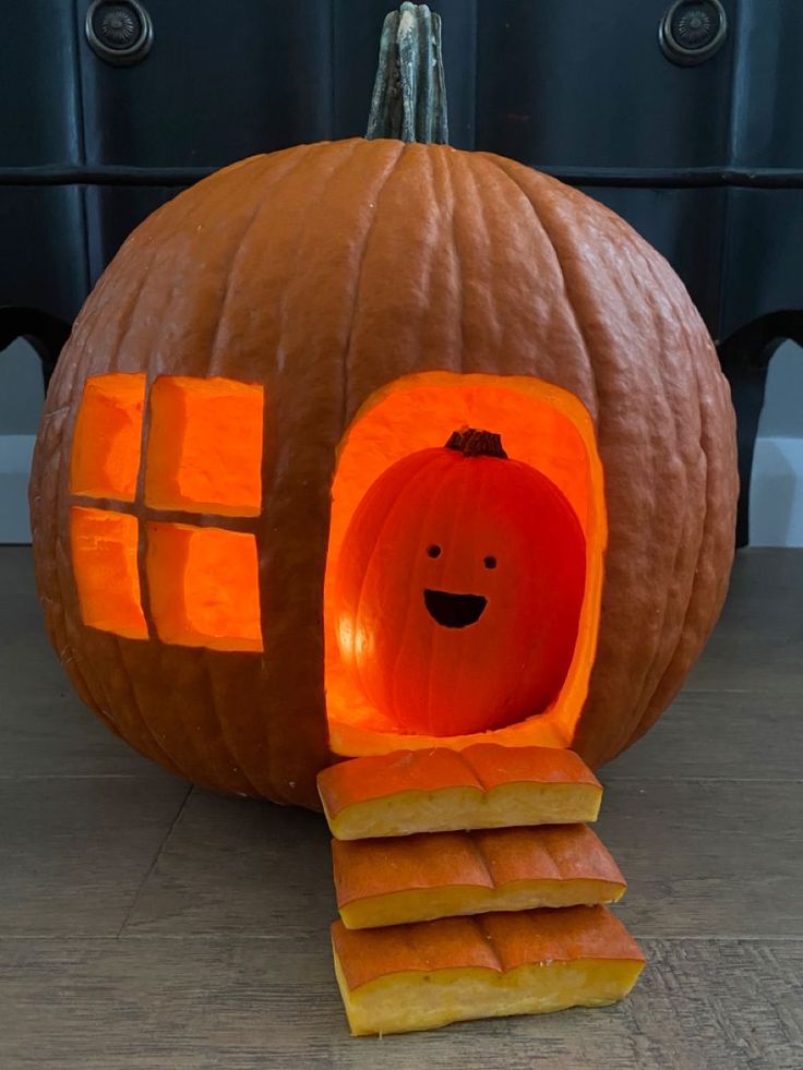 a pumpkin shaped like a house with slices cut out