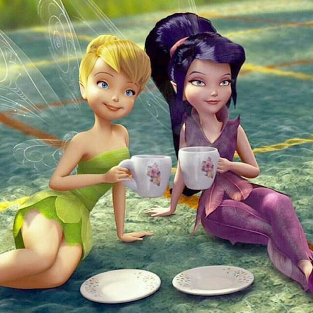 two cartoon tinkerbells sitting on the ground drinking tea