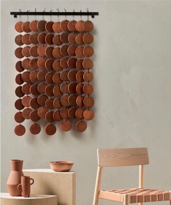 a wall hanging made out of clay pots