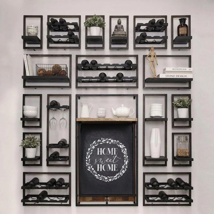 the wall is filled with black shelves and white vases on top of each shelf