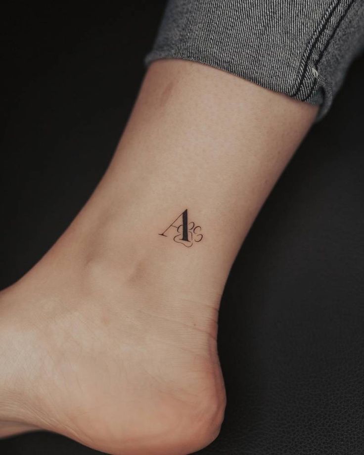 a small letter tattoo on the ankle