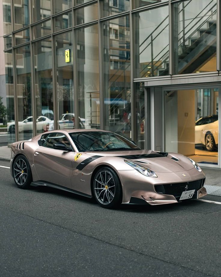 a silver sports car parked in front of a building