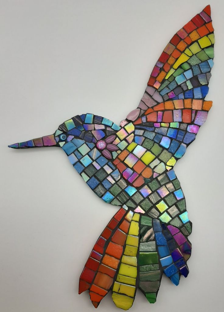 a colorful bird made out of colored glass tiles