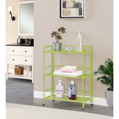 a bathroom with a green shelf next to a mirror