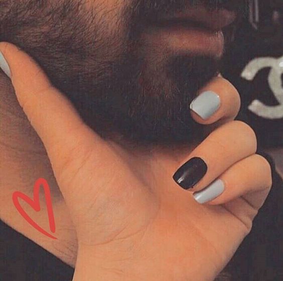 a man with a heart tattoo on his left hand