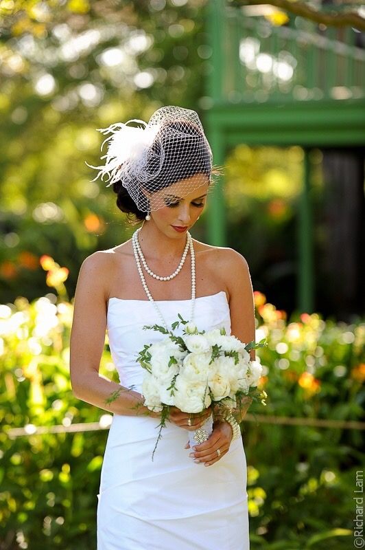 a woman in a white dress holding a bouquet of flowers