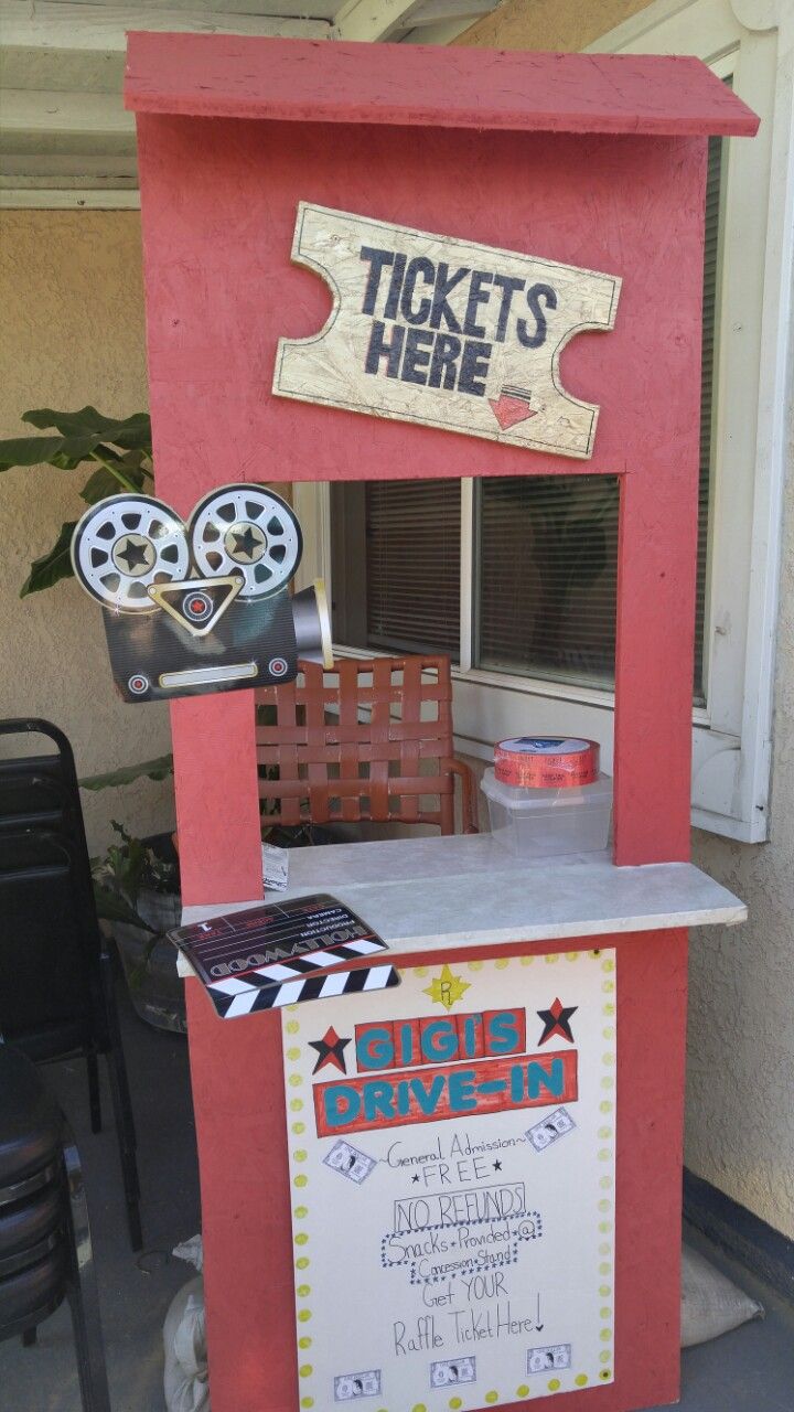 a ticket kiosk is set up in the shape of a drive - in movie theater