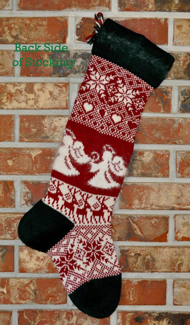 a red and white christmas stocking hanging on a brick wall