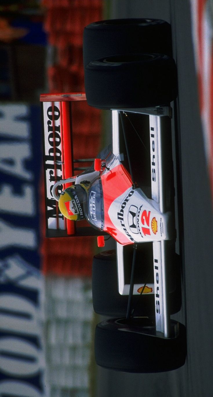 a red and white race car driving on a track