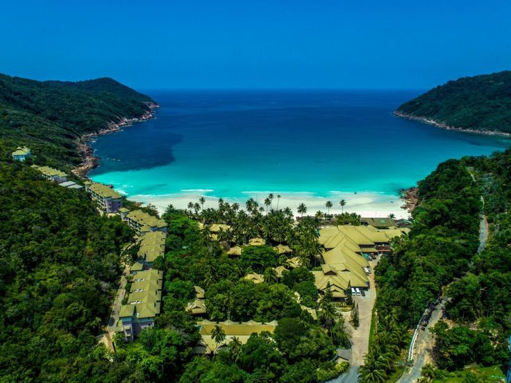 an aerial view of the beach and lagoons in tropical waters, surrounded by green trees