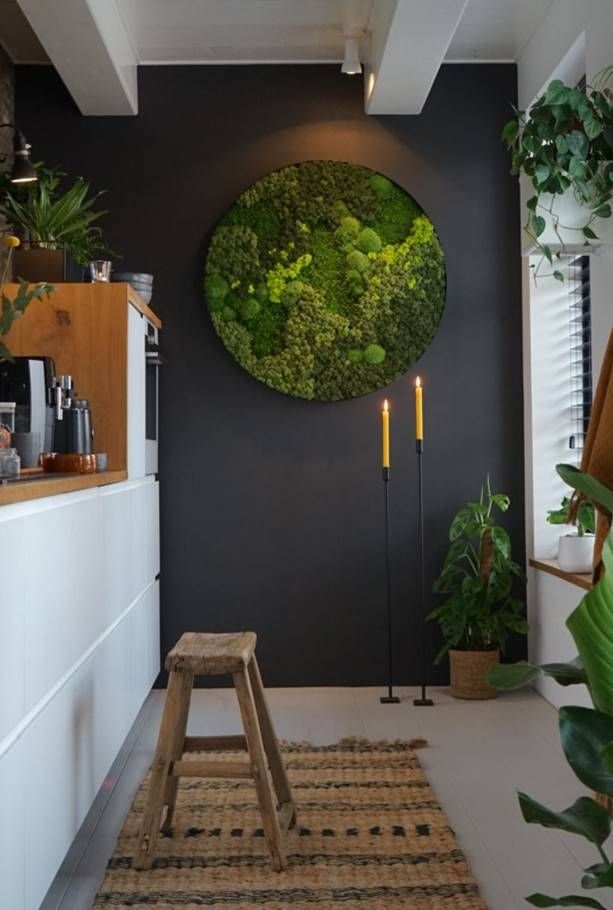 a living room with plants on the wall and a wooden bench in front of it