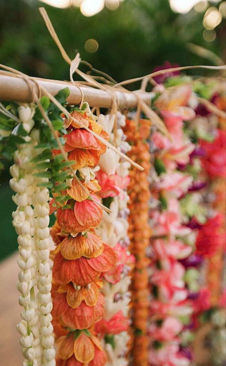 flowers are hanging from a wooden pole