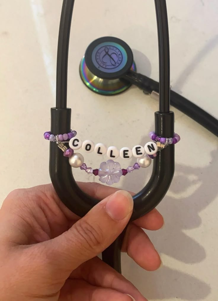 a hand holding a stethoscope with the word collien written on it