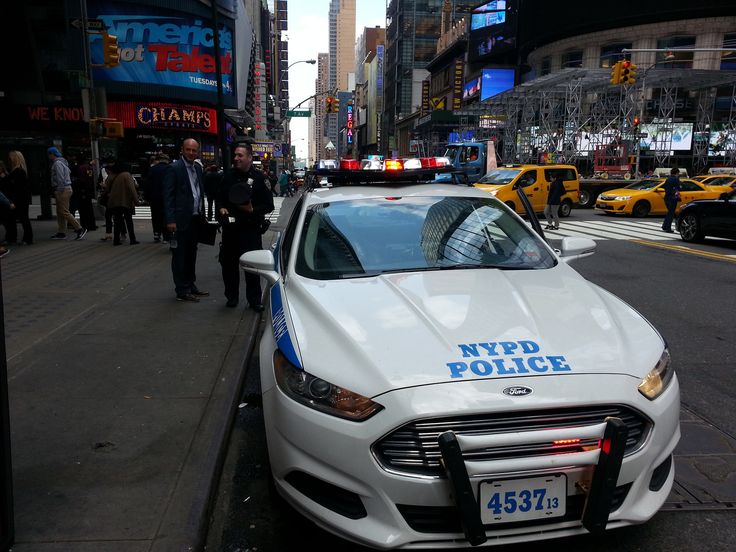 a nypd police car parked on the side of the street in new york city