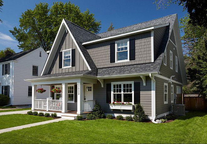 a gray house with white trim and windows