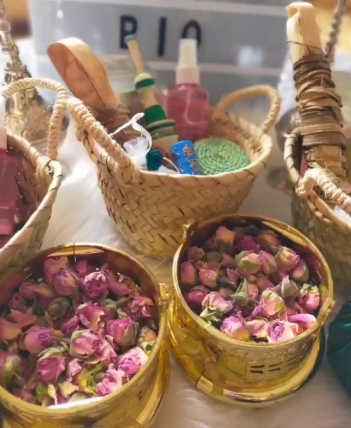 three baskets filled with pink flowers sitting on top of a table next to each other