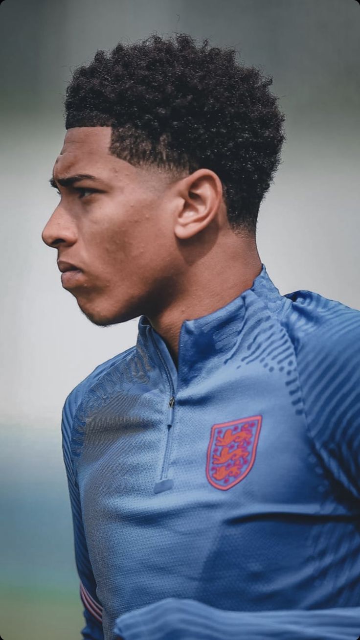 a young man wearing a blue soccer jersey