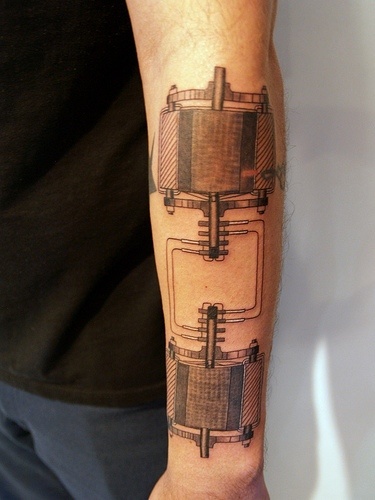 a man with a tattoo on his arm that has an image of a machine in it