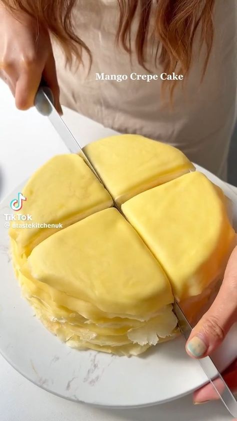 a woman is cutting into a cake on a plate