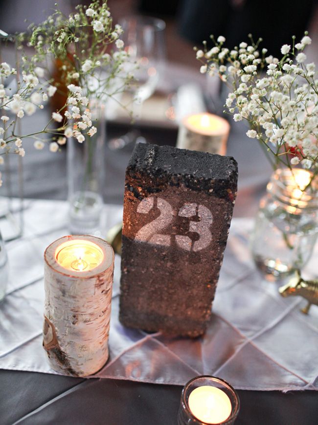 a table with candles and flowers on top of it, next to a number twenty candle holder