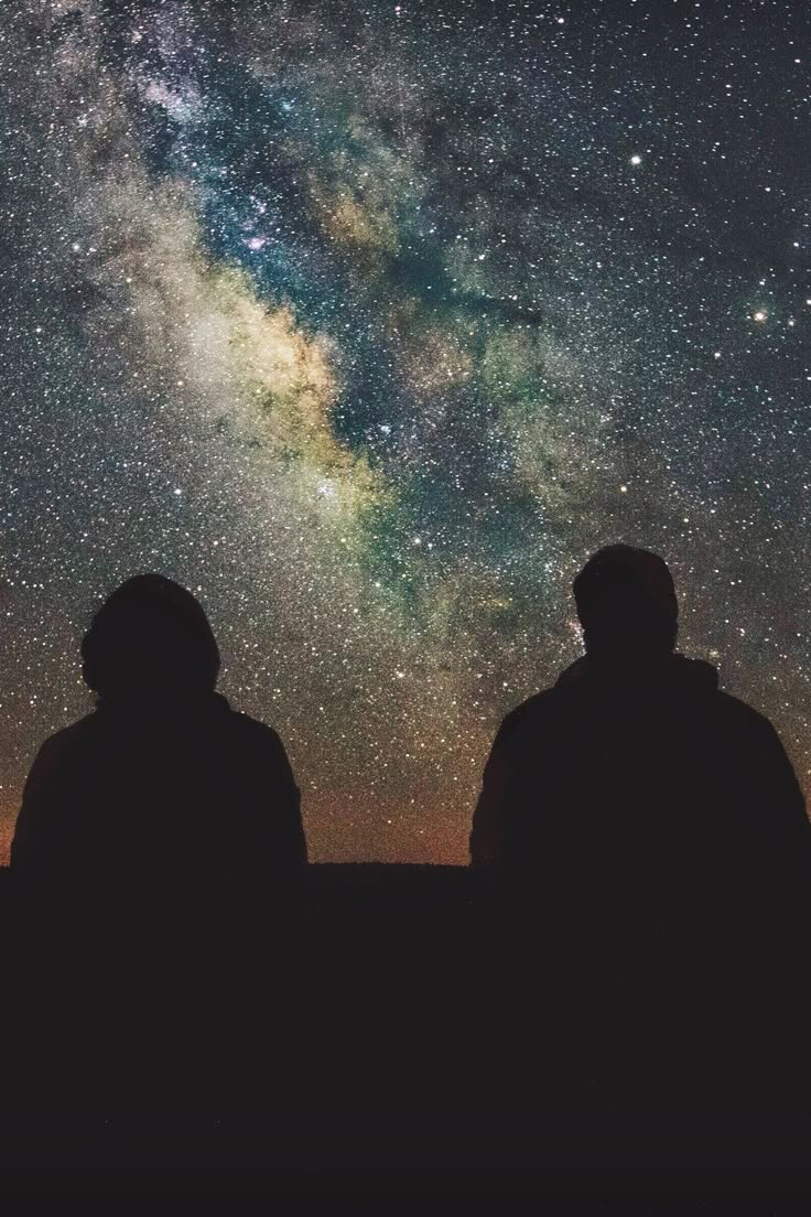 two people looking up at the night sky