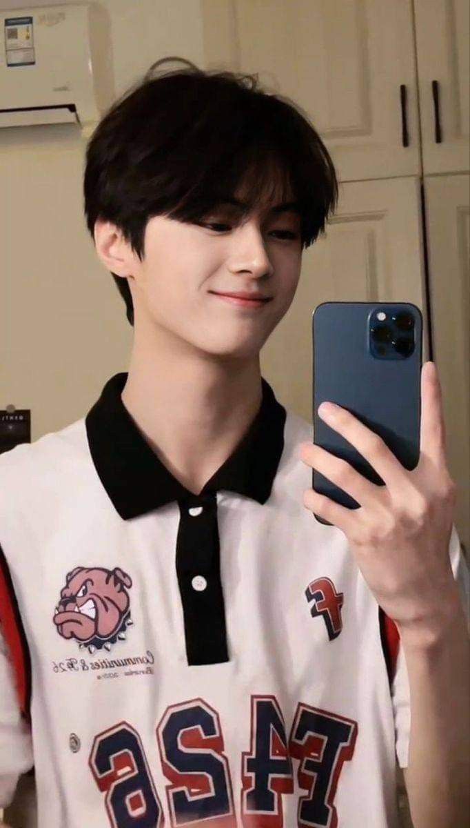 a young man is taking a selfie with his cell phone