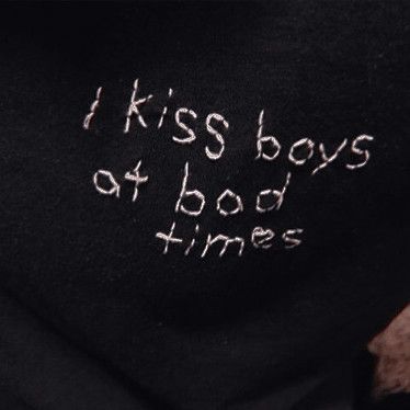 a black shirt with the words i kiss boys at bad times written on it