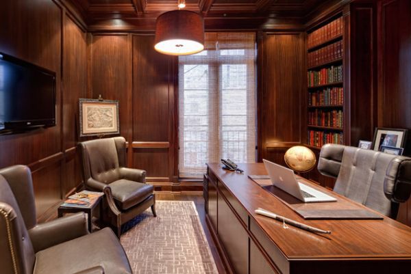 an office with wood paneling and leather chairs in front of a flat screen tv