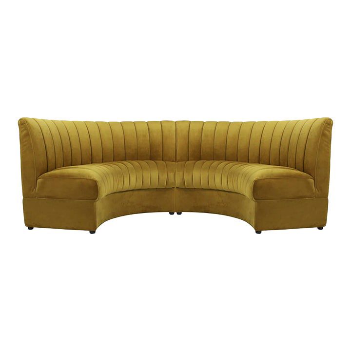 the curved couch is made from yellow velvet