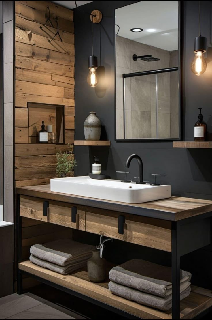 a bathroom with a sink, mirror and light fixtures on the wall next to it