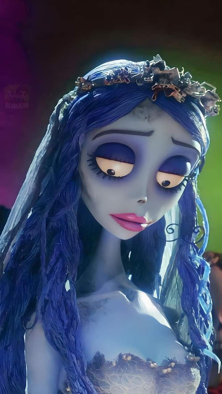 an animated corpse girl with blue hair and white skin wearing a tiara, looking at the camera