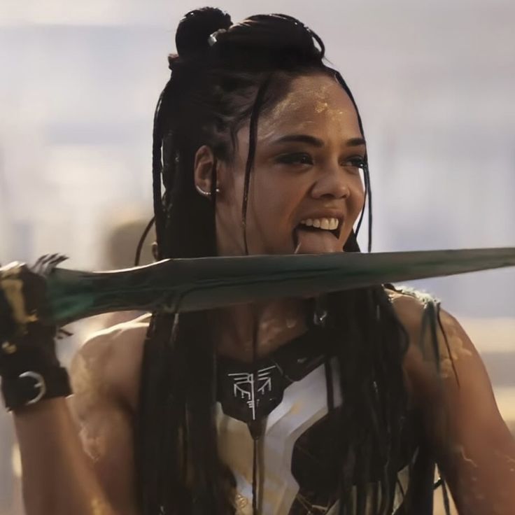 a woman with dreadlocks holding a baseball bat