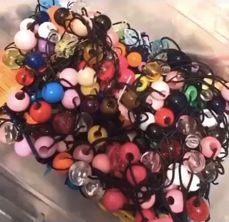 a bunch of beads that are sitting in a container on the floor next to each other