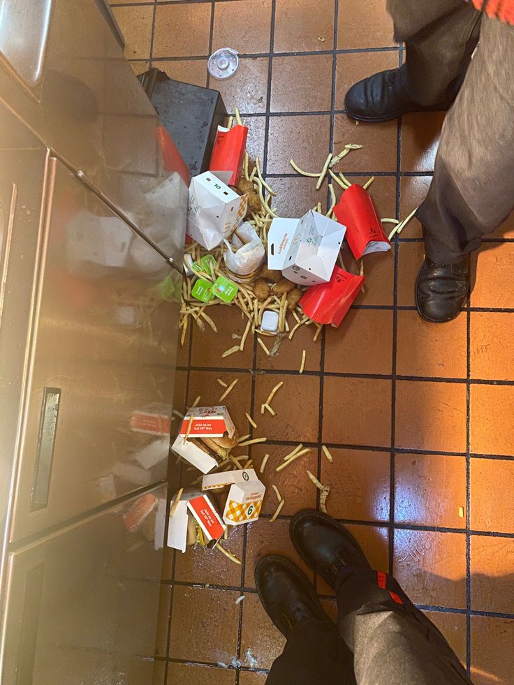 a person standing on a tiled floor next to food