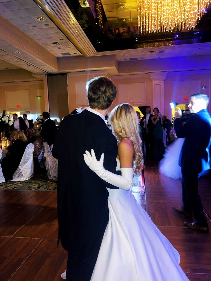 a bride and groom dance together on the dance floor