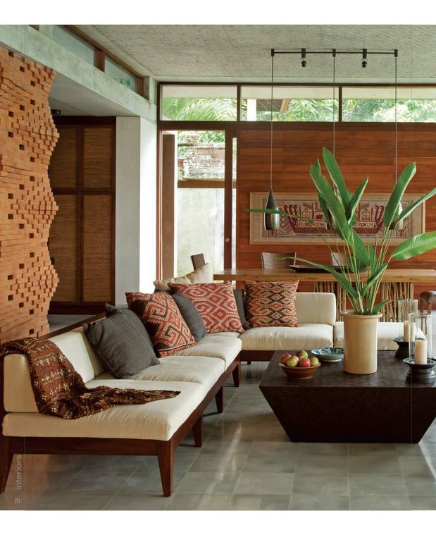 a living room filled with lots of furniture and decor on top of tile flooring