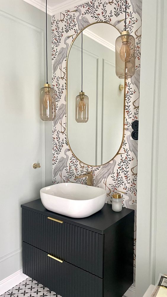 a bathroom with a sink, mirror and lights on the wall next to an open door