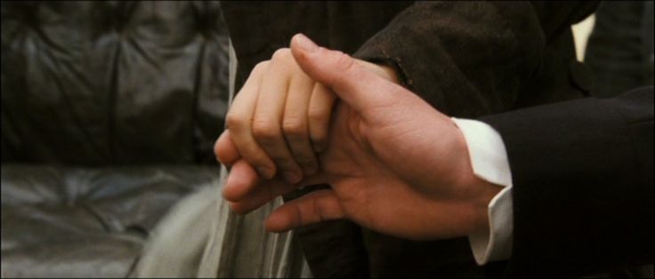 two people holding hands in front of each other