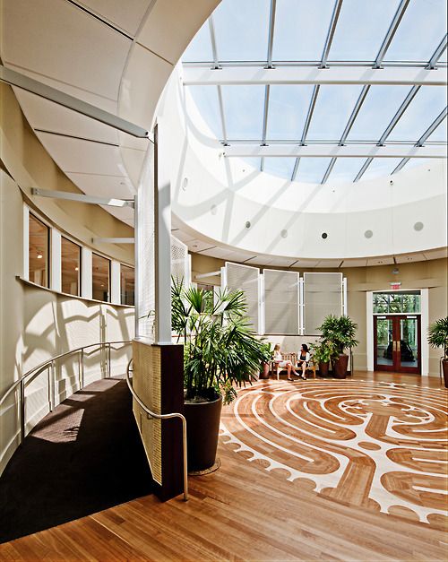 the inside of an office building with wood floors and glass roofing on the ceiling