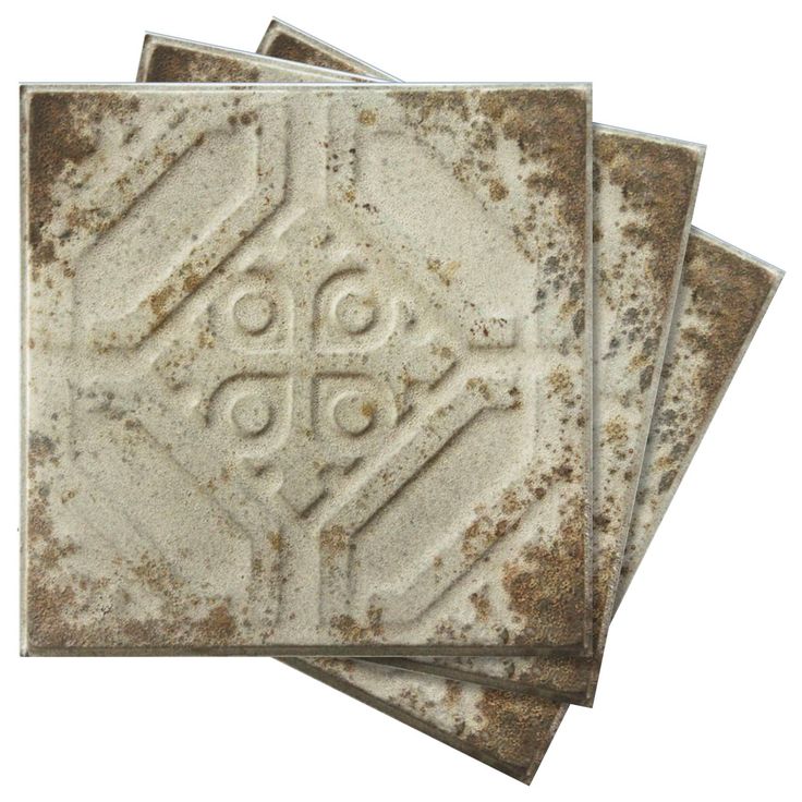 four square tiles with an ornate design on the front and back, set against a white background