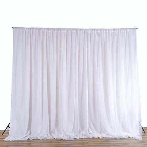 a white backdrop with wooden floors and wood flooring in front of the curtained wall