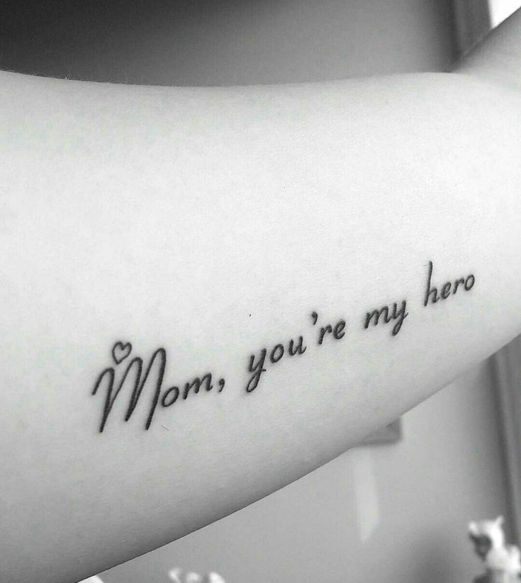 a woman's arm with the words mom, you're my hero on it