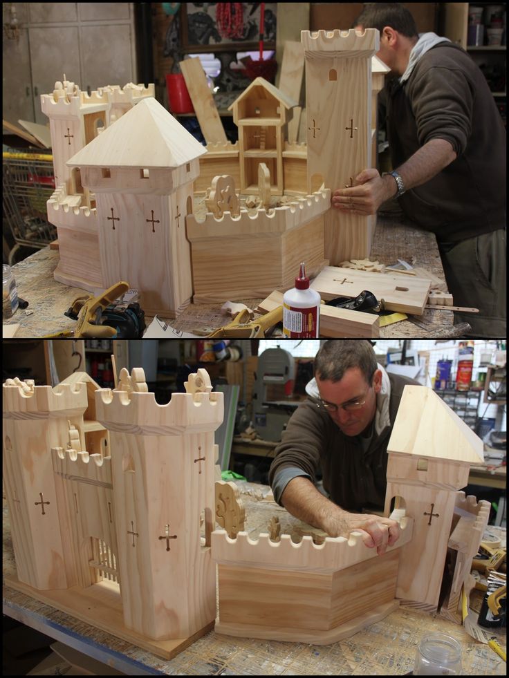 a man working on a model of a castle made out of plywood and wood