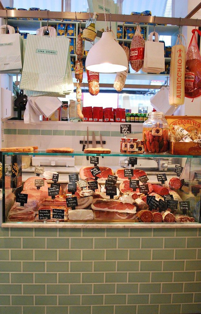 a display case in a store filled with lots of meats and other food items