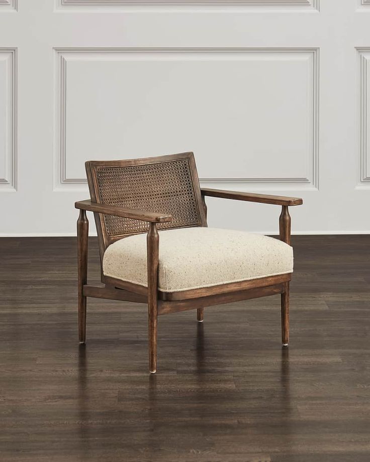 a chair sitting on top of a hard wood floor next to a white painted wall