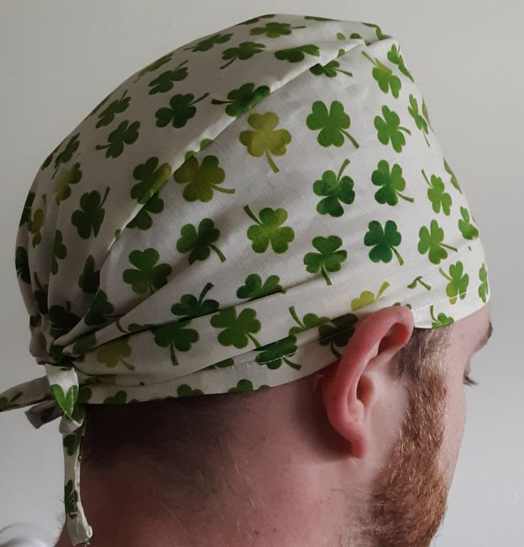 a man wearing a white and green hat with shamrocks on it