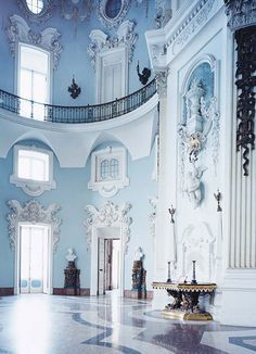 an ornately decorated room with blue walls and marble floors