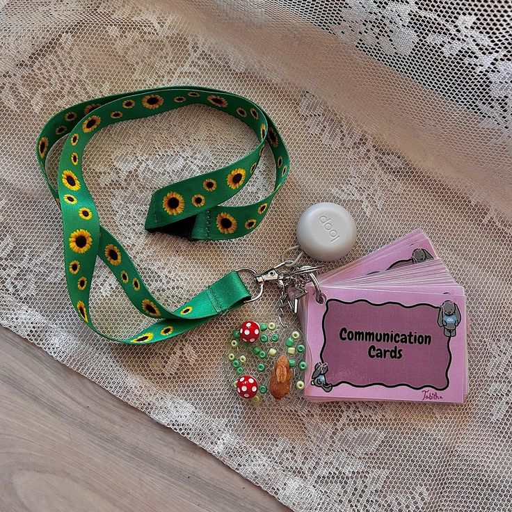 a green lanyard with a badge and some beads on it